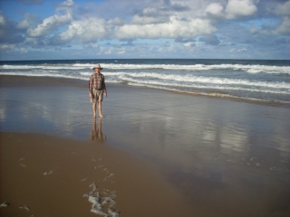 Reflection and shadow on wet sand