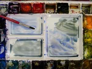 Water colors used to paint island and distant sail boats in this simple watercolor painting